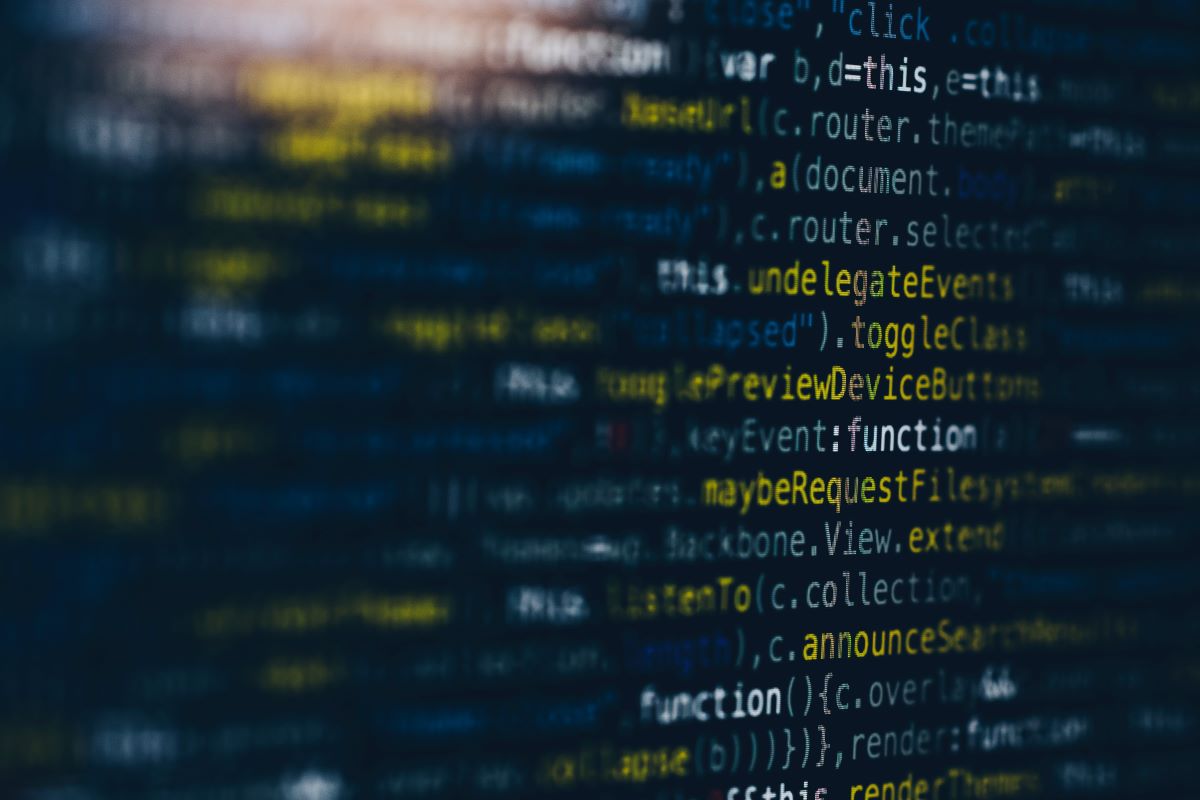 A close-up photo of computer code on a black monitor. Photo by Markus Spiske for Unsplash.