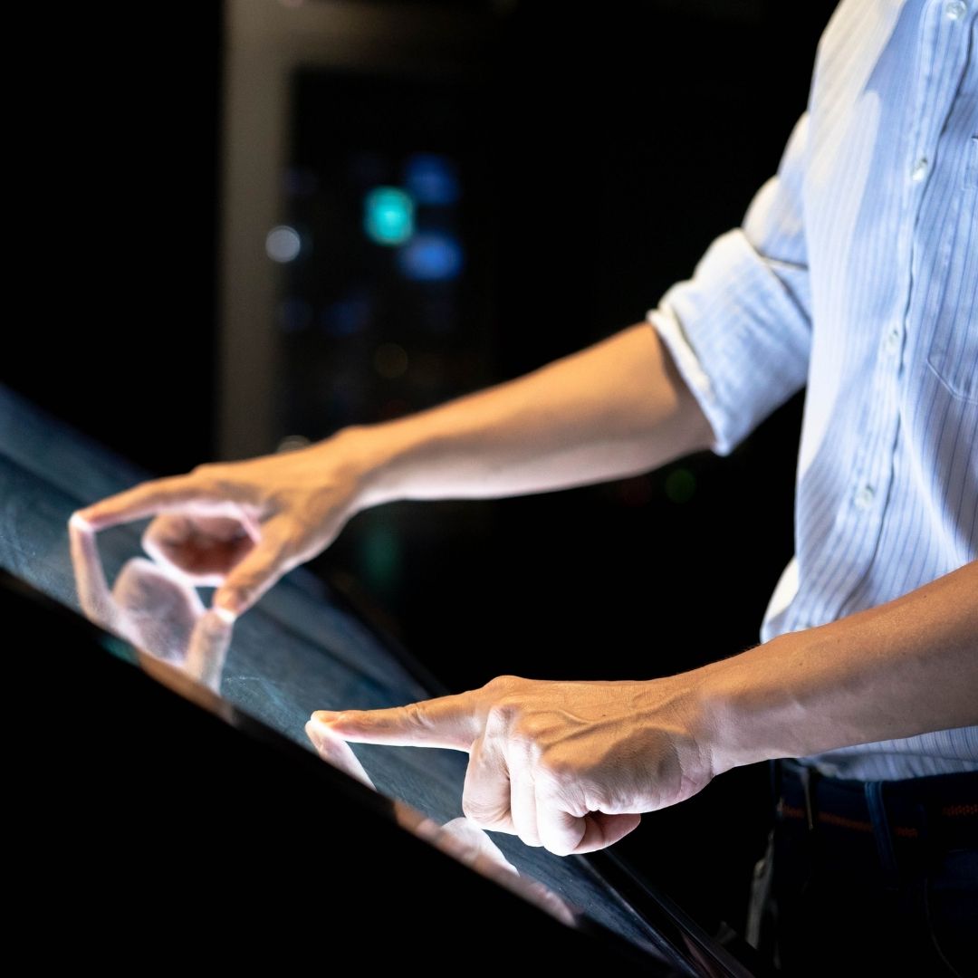 Image of a man touching a kiosk
