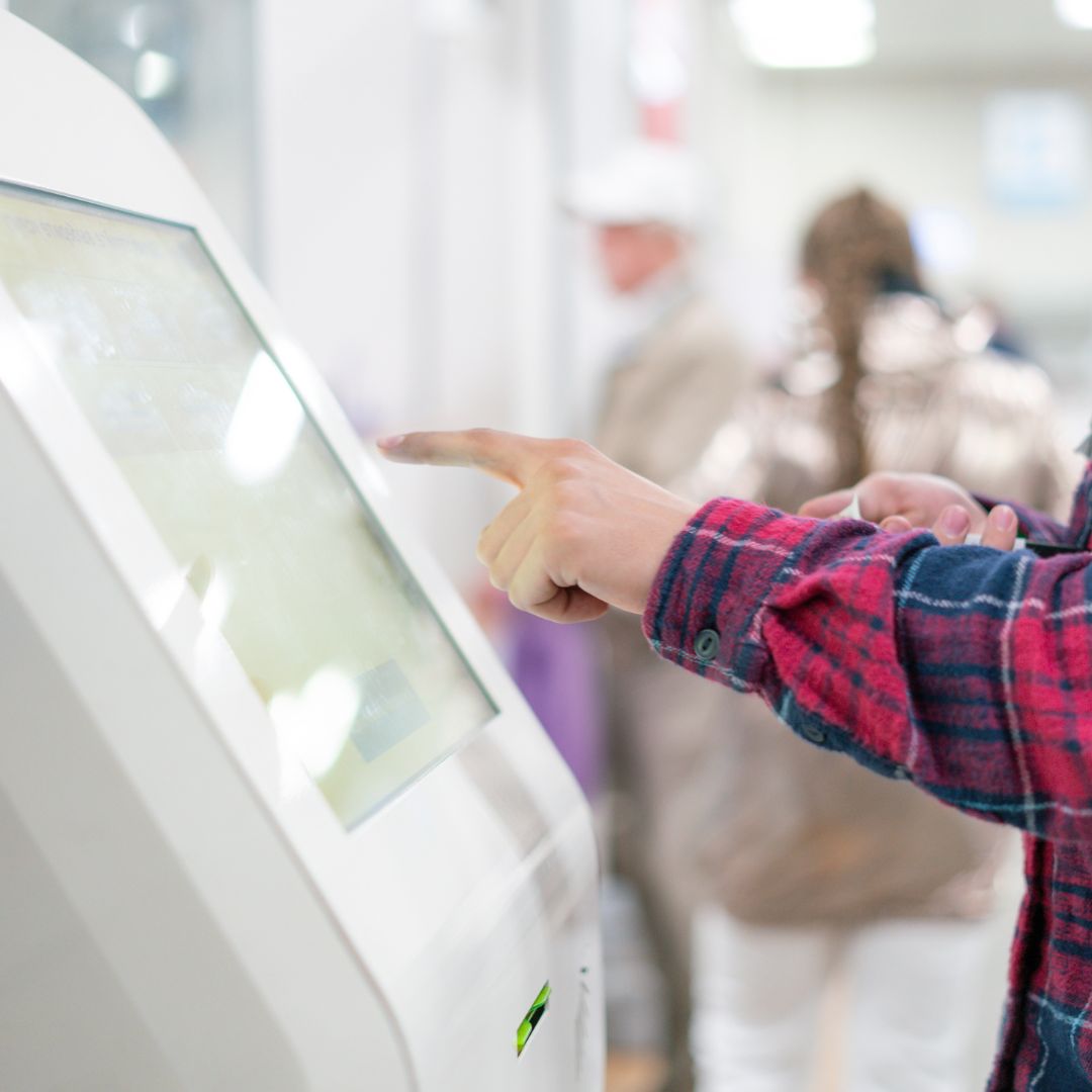 man using kiosk in store