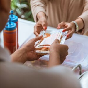 A person receiving a food order