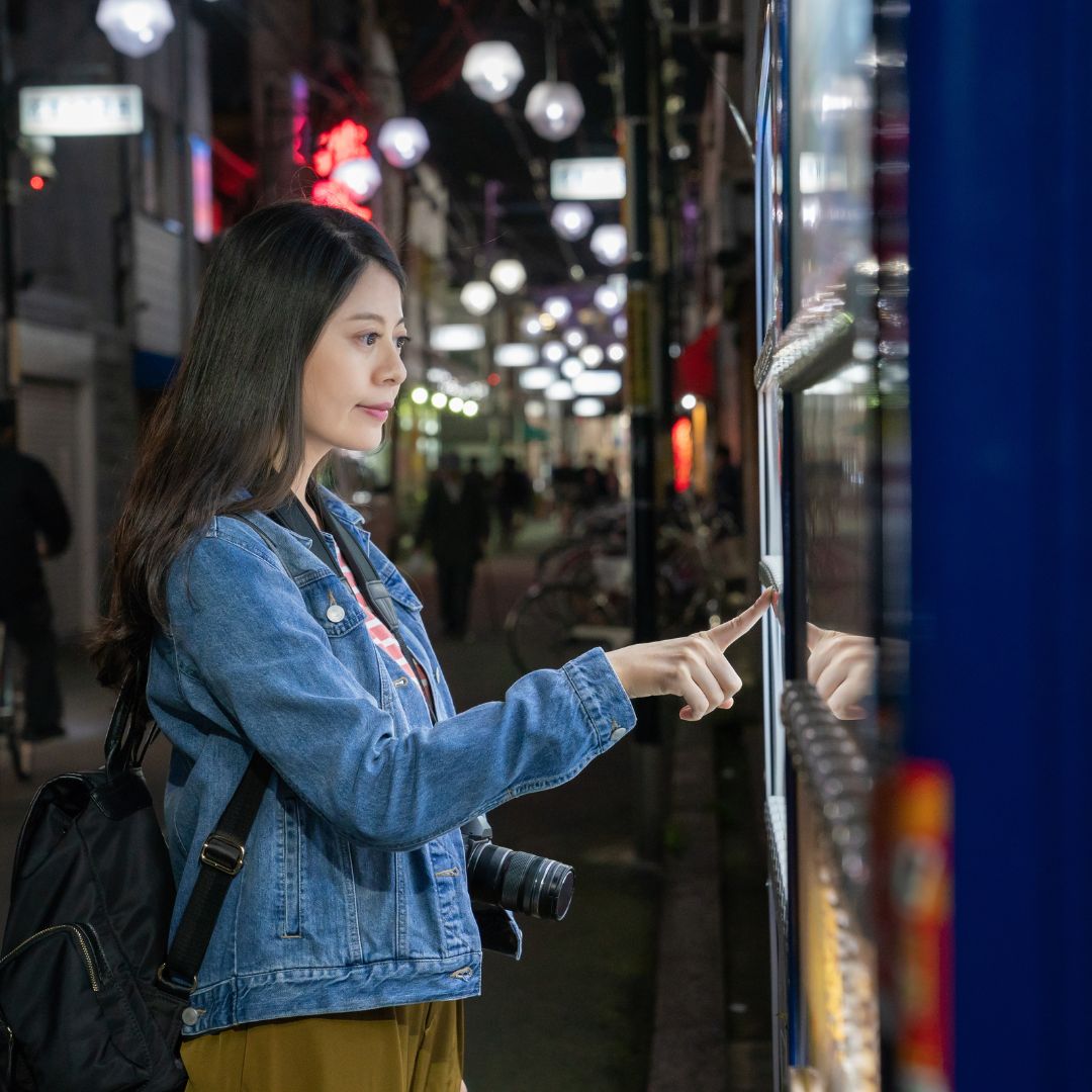 Woman using a kiosk along the street